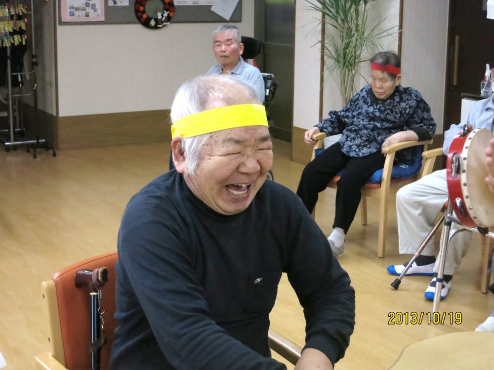 はちまきを巻いて満面の笑顔を見せる利用者さま